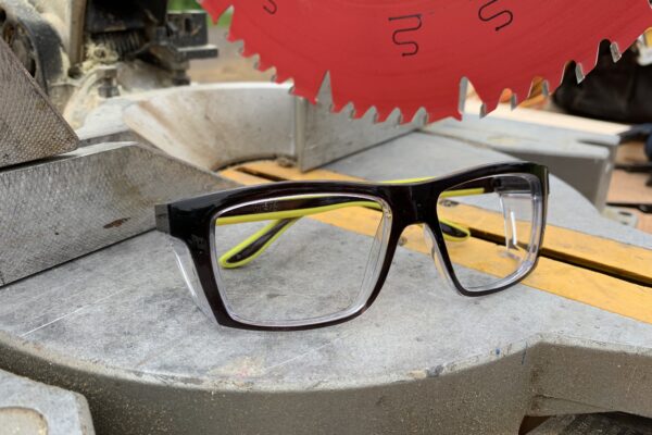 Safety glasses sitting by a table saw